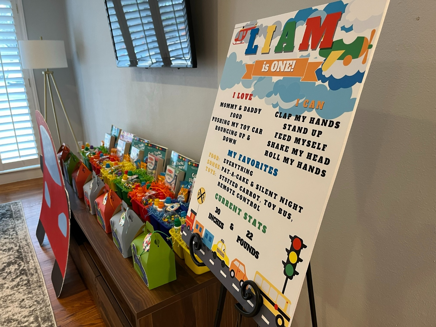 Transportation party favor display with milestone board and gable boxes