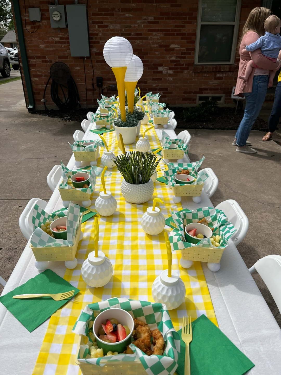 Golf-themed kids party with yellow gingham runner and golf tee centerpieces